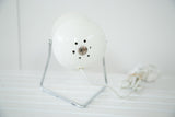 White Mid Century spotlight desk lamp back view, showing vent holes and paint chips.