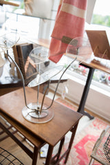 Vintage Lucite hat stand featuring clear acrylic disks and curved chrome supports.