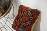 Rich red, navy, and ochre diamond pattern on the antique Afghani rug fragment pillow.
