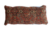 Antique Bijar rug fragment pillow featuring intricate traditional red and blue motifs.