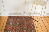 Intricate late 19th-century Bijar rug fragment featuring bold red, blue, and ivory patterns.
