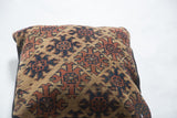 Antique Turkmen rug fragment pillow with deep brown and khaki geometric pattern.