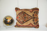 Vintage camel hair Serab floor pillow, geometric pattern in camel, red, and blue.