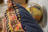 Plush vintage Serab rug fragment and navy blue cotton canvas on a floor pillow.
