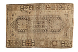 Geometric distressed vintage Caucasian rug featuring natural brown and camel tones, 3' x 4'6