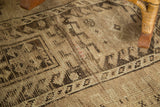 Distressed texture revealing geometric patterns in natural brown and camel hues.