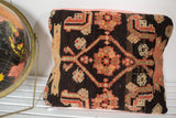 Antique Northwest Persian rug fragment pillow with charcoal and peach geometric allover design.