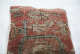 Hand-knotted antique Heriz rug fragment texture featuring rich red tones and aged patina.
