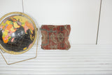 Antique Heriz rug fragment pillow in a rich red, tan, and blue geometric design.