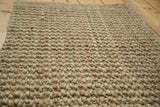 Textured close-up of the hand braided beige entrance mat's natural weave.