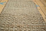 Hand braided texture of natural beige hemp and jute fibers on the entryway mat.