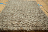 Close-up of the hand-braided grey entrance mat, highlighting the natural fiber texture and sturdy edge.