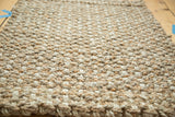 Close-up of the hand braided beige mat, showcasing durable interwoven hemp, jute, and sisal texture.