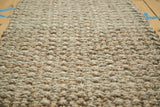 Hand-braided texture of natural beige and brown fibers.