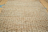Hand braided texture of the gold entrance mat, made from natural fibers.