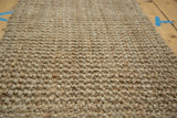 Hand-woven texture of natural beige hemp, jute, and sisal entrance mat.