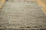 Tight, hand-braided grey entrance mat texture from natural fibers.