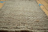 Close-up of the beige natural fiber hand-braided entrance mat texture.