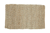 Hand braided beige entrance mat with a dense natural fiber weave.