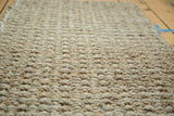 Hand-braided texture of natural hemp, jute, and sisal beige entrance mat.