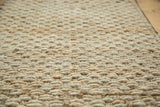 Coarse, hand braided weave texture of the natural gold entrance mat.