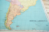 Detailed cartography of Argentina on a vintage pull-down map, showing the scale and legend in the corner.