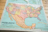 Close-up of antique Nystrom pull-down map showing vibrant Western US, Mexico, and visible textural bowing.