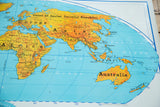 Vintage Denoyer Geppert world map section featuring bright yellow continents and blue oceans.