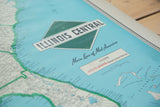 Vintage Illinois Central map legend with red railroad lines, scale, and turquoise Bahamas.