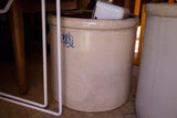 Antique beige 8 gallon crock with blue clover design.
