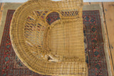 Top-down view of the vintage boho wicker child's chair's woven seat and back.