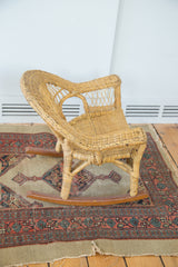 Natural woven texture of the vintage boho wicker child's chair seat and legs.