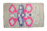 Vintage homemade American Kilim mat with bright pink, blue, and purple geometric design.