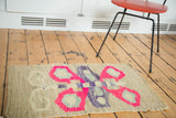 Retro homemade American Kilim mat with bright pink butterfly motif.