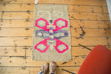 Modern abstract hand-woven American Kilim rug with hot pink and teal butterfly motif.