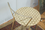Hollywood Regency stool, geometric hexagonal seat pattern, curved brass backrest.
