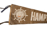 White ship wheel logo with sailboat on vintage brown felt pennant.