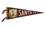 Santa Fe NM vintage felt flag pennant, burgundy with white text and drummer illustration, 8.5 x 27 inches.