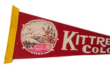 Red felt Kittredge Colorado pennant, angled view, with yellow trim and mountain illustration.