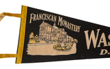 Vintage felt pennant showing cream Franciscan Monastery illustration on black with yellow trim.