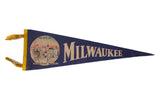 Vintage felt pennant in navy blue with Milwaukee skyline, gold lettering, and yellow ties.