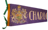 Detailed royal crest and green ties on a purple vintage felt Charlottetown flag.