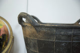 Detail of the dark recycled rubber basket, highlighting its textured handle and herringbone pattern.