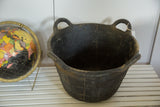 Textured charcoal recycled rubber basket with a worn rim and handle.