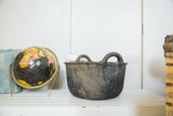 Dark recycled rubber basket with textured sides, subtle geometric pattern, and two integrated handles.