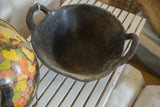 Close-up of the dark recycled rubber basket, showing its textured handle and rim.