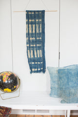 Handmade vintage indigo blue batik wall hanging with light patterns and raw edges.