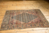 Farahan Sarouk rug, late 19th century, showing tattered edge and intricate floral border.