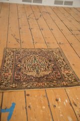 Angled view of a vintage Josan Sarouk mat showing its stepped medallion and soft color palette.