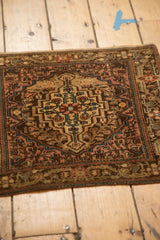 Angled view of a traditional Josan Sarouk mat showing its short pile and softened bronze and blush tones.
